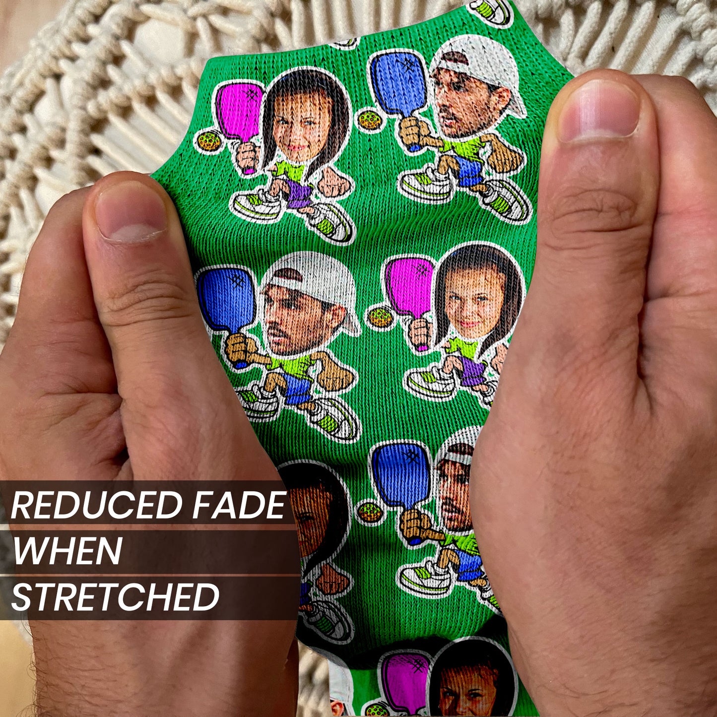 green socks with real photos of a male and female cropped on cartoon pickleball characters stretched to show how the image holds
