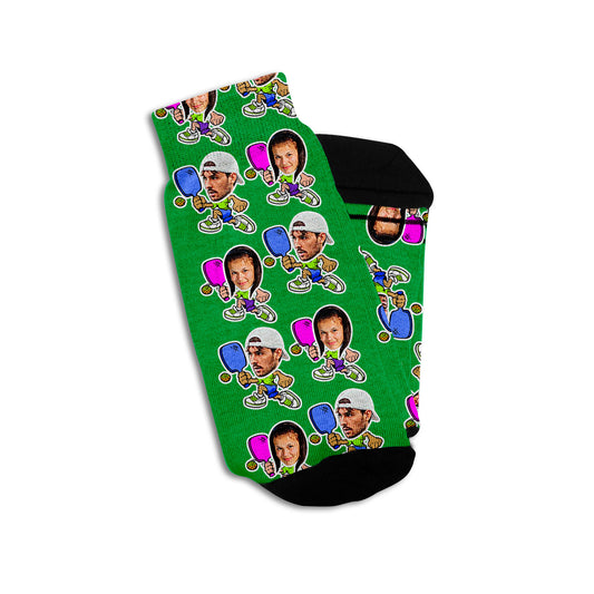 pickleball socks in green on a mans feet featuring a male and female photo on cartoon bodies